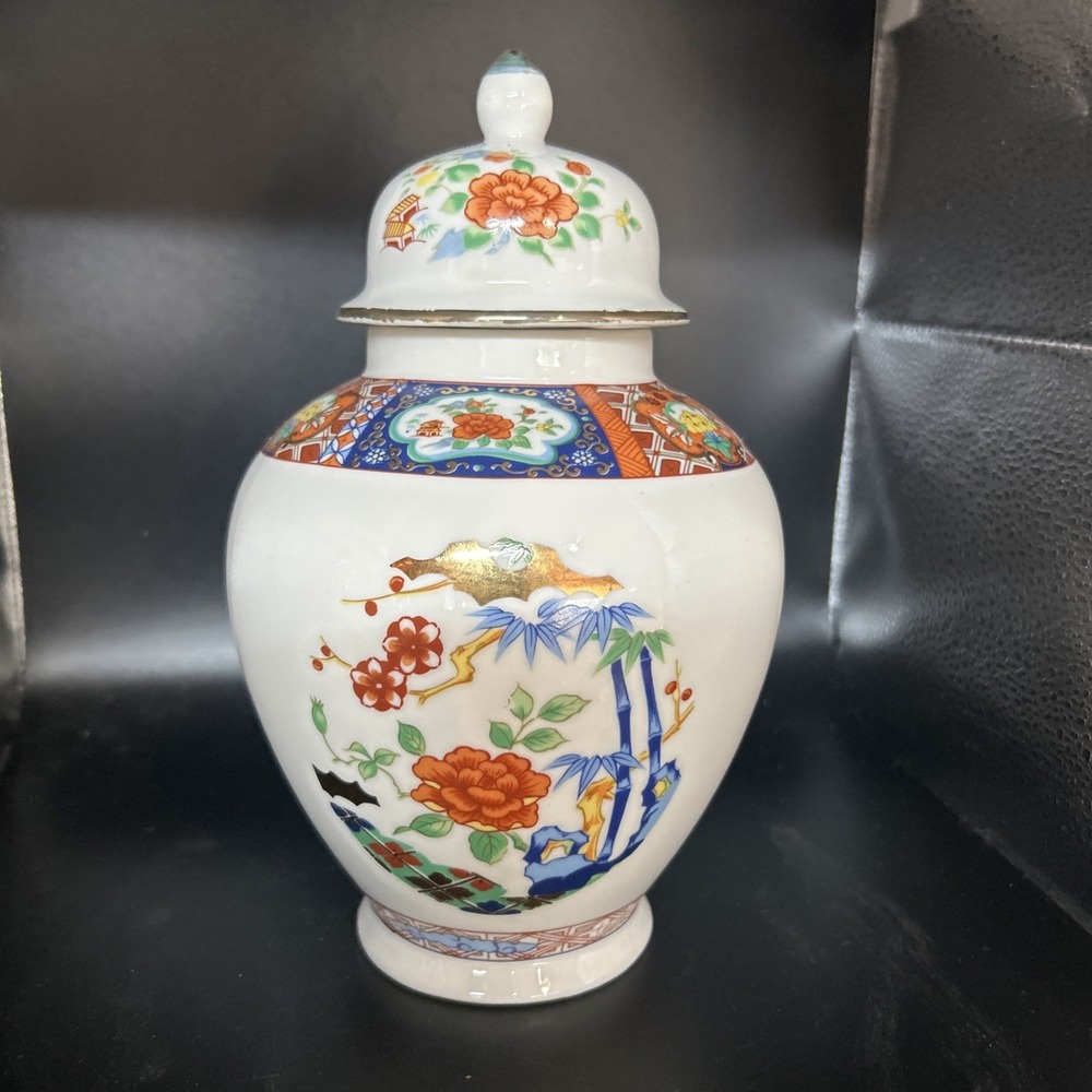 Asian ginger jar with floral and geometric illustrations and trimmed with gold